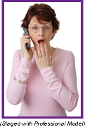 Woman on phone with shocked expression on her face (Staged with profesisonal model).
